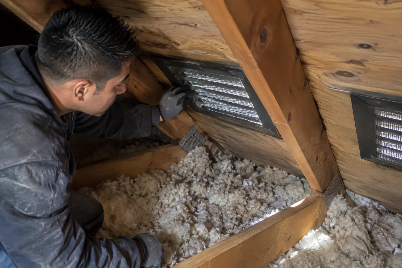 Installing and securing an attic soffit vent screen amid loose-fill insulation to maintain proper airflow after a clean-up.